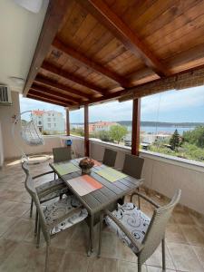 a table and chairs on a balcony with a view at House Stojakovic in Banjol
