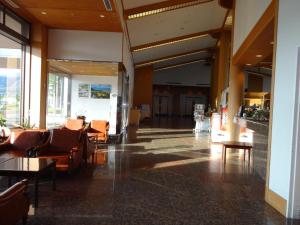 a lobby with chairs and tables in a building at Grand Park Hotel Okubiwako Makino in Takashima