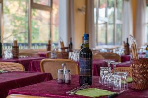a bottle of wine sitting on a table in a restaurant at HOTEL CONCORDIA in Montecatini Terme