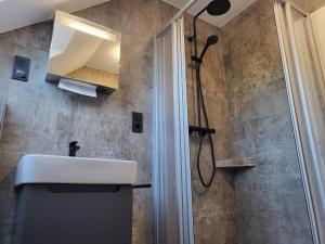 a bathroom with a sink and a shower at FeWo-Brak in Norden +15 photos