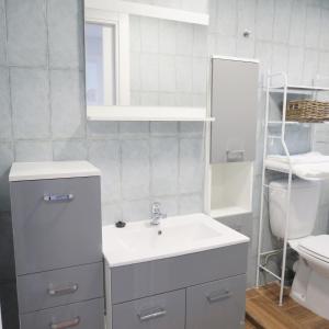 a bathroom with a sink and a mirror and a toilet at Piso Virgen del mar in Laxe +28 photos