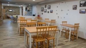 a dining room with wooden tables and chairs at The Village House by CDV in Carrazeda de Anciães
