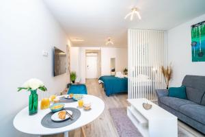 a living room with a table and a couch at Downtown MaritA207 in Dubrovnik
