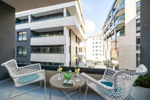 a balcony with a table and chairs and a building at Downtown MaritA207 in Dubrovnik