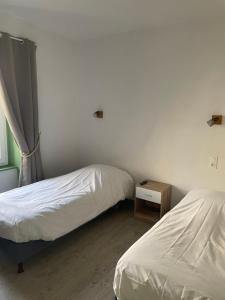 Postel nebo postele na pokoji v ubytování Le Lion d'Or + 4 fotografie