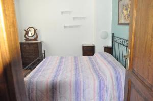 a bedroom with a bed and a dresser in it at Farm stay Il Carro del Colle in Collevalenza
