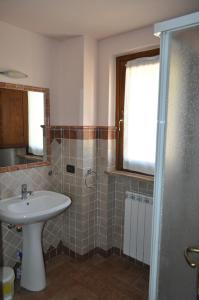 a bathroom with a sink and a shower at Farm stay Il Carro del Colle in Collevalenza