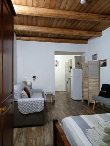 a living room with two beds and a refrigerator at Bed and breakfast Raggio di Sole in Iglesias