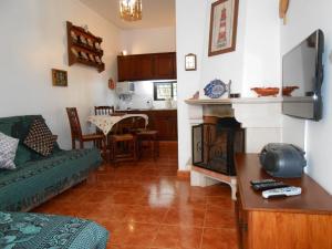 a living room with a couch and a fireplace at Villa Cabanas in Tavira