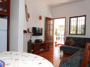 a living room with a couch and a tv at Villa Cabanas in Tavira +12 photos