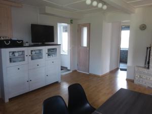 a living room with a tv on top of a cabinet at Tuule Villa in Kuressaare