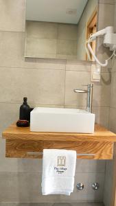 a bathroom with a sink and a towel on a shelf at The Village House by CDV in Carrazeda de Anciães