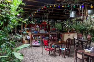 a restaurant with tables and chairs in a garden at Finca Los Abuelos - La Planta in Concepción