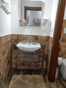a bathroom with a sink and a mirror at Raggio di Sole in Iglesias