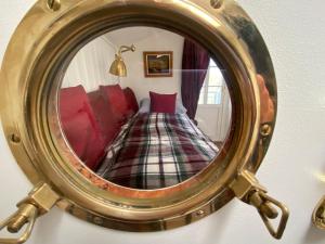 a person taking a picture of a bed in a mirror at Hotel Lili Marleen in Travemünde
