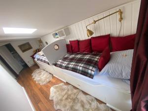 a bedroom with a bed with red pillows at Hotel Lili Marleen in Travemünde