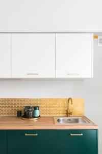 a kitchen with a sink and a counter top at Lux Apartment II in Gdańsk