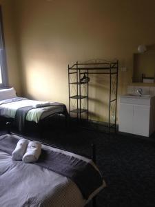 a room with two beds and a sink and a counter at Hotel Cessnock in Cessnock