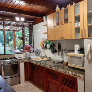 A kitchen or kitchenette at Senz Chalet Riverside - Mindo