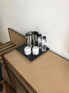 a tea kettle and two bottles of water on a table at Hotel Monegal in Barcelona