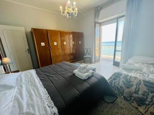 Posteľ alebo postele v izbe v ubytovaní Casa Vacanze Porto delle Gatte