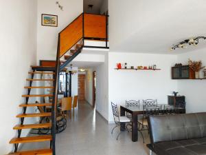 a staircase in a house with a dining room and a table at Duplex vista mar Peñiscola Playa Orangecosta in Peniscola