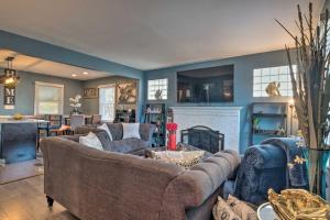 a living room with couches and a fireplace at Capitol Heights Home about 5 Mi to National Mall! in Capitol Heights
