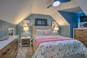 a bedroom with a bed and a blue wall at Capitol Heights Home about 5 Mi to National Mall! in Capitol Heights