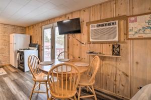 a kitchen and dining room with a table and chairs at Quaint Table Rock Lake Hideout with Pool Access in Reeds Spring