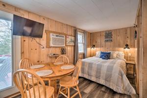a bedroom with a bed and a table and chairs at Quaint Table Rock Lake Hideout with Pool Access in Reeds Spring +21 photos