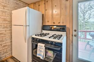 a kitchen with a white stove and a refrigerator at Quaint Table Rock Lake Hideout with Pool Access in Reeds Spring