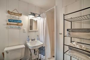 a bathroom with a sink and a toilet and a shower at Quaint Table Rock Lake Hideout with Pool Access in Reeds Spring