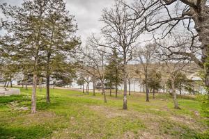 a park with trees and grass and buildings at Quaint Table Rock Lake Hideout with Pool Access in Reeds Spring