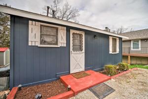 a house with a blue garage with a door at Quaint Table Rock Lake Hideout with Pool Access in Reeds Spring