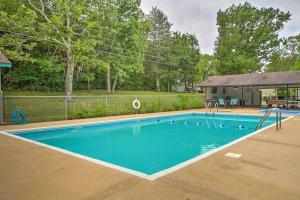 a swimming pool in the middle of a yard at Quaint Table Rock Lake Hideout with Pool Access in Reeds Spring
