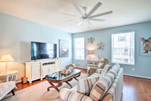 a living room with a couch and a tv at Ocean City Home Boat Slip, Stunning Bay View in Ocean City