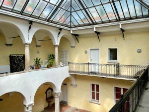 an empty building with a glass roof and two balconies at Great2Stay City Center Apartments Locarno in Locarno