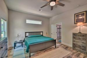 a bedroom with a bed and a ceiling fan at Newly Constructed Mansfield Home with Fenced Yard! in Mansfield