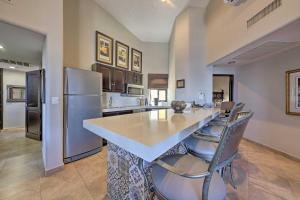 a large kitchen with a large island with bar chairs at Resort-Style Cabo Getaway with Pools & Ocean Views in Cabo San Lucas