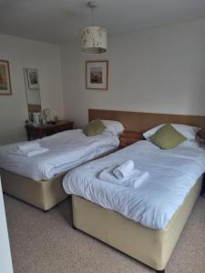 two beds sitting next to each other in a room at ROYAL OAK in Kinnersley
