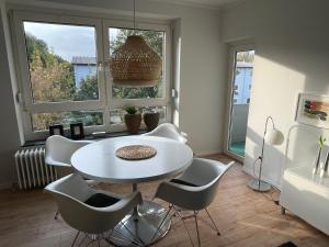 a dining room with a white table and chairs at Angie´s Home in Saarlouis