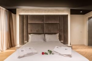 a bedroom with a large bed with two towels on it at Brera Luxury Apartment near Duomo With Wifi in Milan
