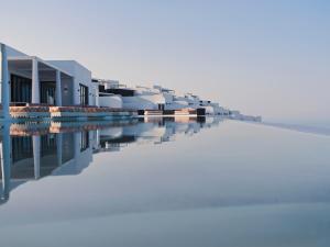 a row of houses and a swimming pool at Cresanto Luxury Suites in Imerovigli