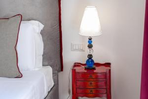A bed or beds in a room at Suite della Pigna