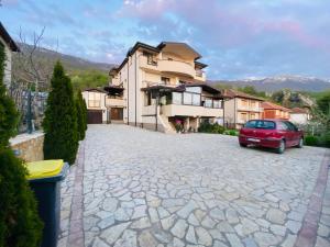 a red car parked in front of a house at Villa Koceski in Peštani