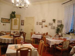 un comedor con mesas y sillas y una lámpara de araña en Haus am Pfaffenteich, en Schwerin