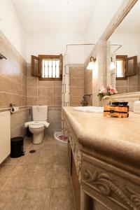a bathroom with a sink and a toilet and a tub at VILLA KONSTANTINA Sidari in (( Sgoúrna ))