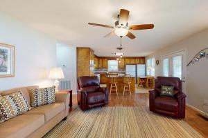 a living room with a couch and a ceiling fan at Paradise Point in Lake Murray Shores