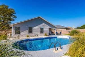 a swimming pool in front of a house at Happy Home in Perdido Key