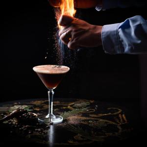 a man is sprinkling a cocktail on a table at Ice House Hotel in Ballina